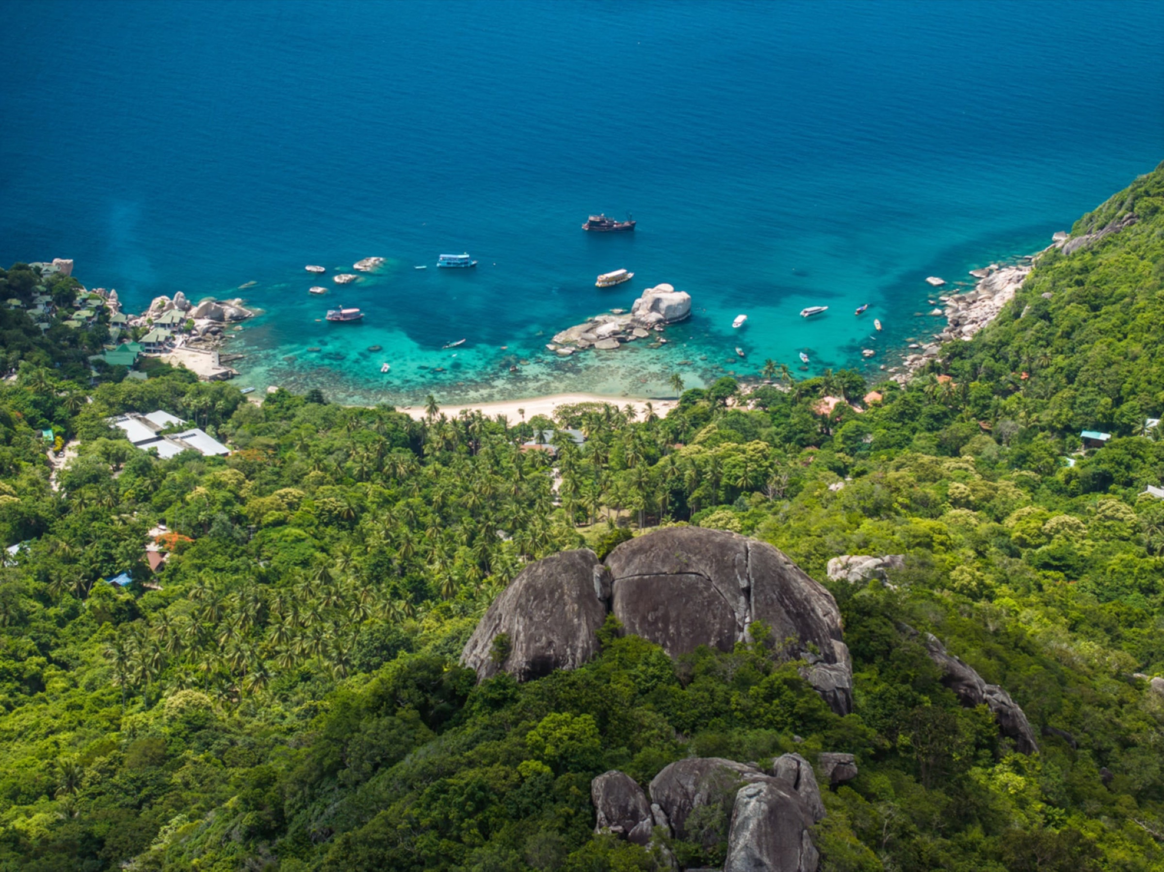 Koh Tao from above — boulders, jungle, and turquoise bay